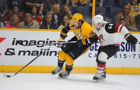 Apr 7, 2016; Nashville, TN, USA; Nashville Predators right winger James Neal (18) skates with the puck around Arizona Coyotes defenseman Kevin Connauton (44) during the first period at Bridgestone Arena. Mandatory Credit: Christopher Hanewinckel-USA TODAY Sports