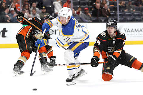 ANAHEIM, CALIFORNIA – OCTOBER 28: Victor Olofsson #71 of the Buffalo Sabres controls the puck through the defense of Jamie Drysdale #34 and Troy Terry #16 of the Anaheim Ducks during overtime of a game at Honda Center on October 28, 2021 in Anaheim, California. (Photo by Sean M. Haffey/Getty Images)