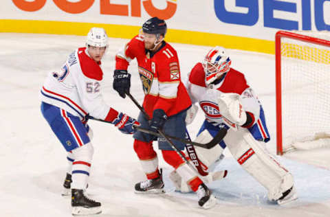 SUNRISE, FL – MARCH 29: Justin Barron #52 and goaltender Jake Allen #34 of the Montreal Canadiens defend against Jonathan Huberdeau #11 of the Florida Panthers during the second period at the FLA Live Arena on March 29, 2022 in Sunrise, Florida. (Photo by Joel Auerbach/Getty Images)