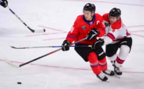 Jan 25, 2023; Langley, BC, CANADA; CHL Top Prospects team red forward Connor Bedard (98) controls the puck against CHL Top Prospects team white defenseman Hunter Brzustewicz (4) during the third period in the 2023 CHL Top Prospects ice hockey game at Langley Events Centre. Mandatory Credit: Anne-Marie Sorvin-USA TODAY Sports