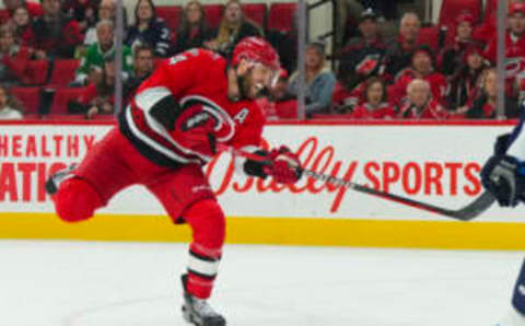 Mar 14, 2023; Raleigh, North Carolina, USA; Carolina Hurricanes defenseman Jaccob Slavin (74) shoots against the Winnipeg Jets during the first period at PNC Arena. Mandatory Credit: James Guillory-USA TODAY Sports