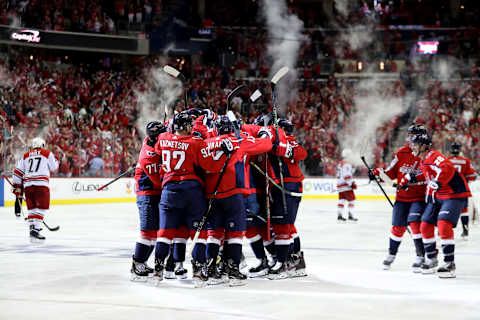 WASHINGTON, DC – APRIL 13: Brooks Orpik #44 of the Washington Capitals is mobbed by teammates after scoring the game winning goal in overtime giving the Capitals a 4-3 win over the Carolina Hurricanes in Game Two of the Eastern Conference First Round during the 2019 NHL Stanley Cup Playoffs at Capital One Arena on April 13, 2019 in Washington, DC. (Photo by Rob Carr/Getty Images)