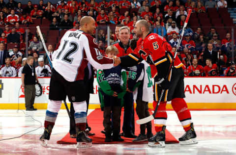 CALGARY, AB – JANUARY 4: Mark Giordano #5 of the Calgary Flames and Jarome Iginla #12 of the Colorado Avalanche shake hands for a ceremonial puck drop. (Photo by Gerry Thomas/NHLI via Getty Images)