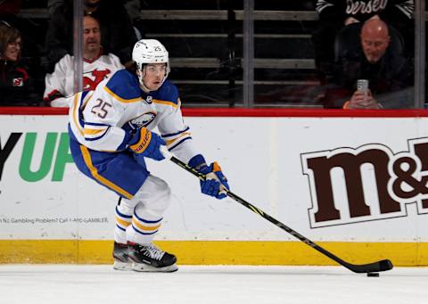 NEWARK, NEW JERSEY – APRIL 21: Owen Power #25 of the Buffalo Sabres takes the puck during the first period against the New Jersey Devils at Prudential Center on April 21, 2022 in Newark, New Jersey. (Photo by Elsa/Getty Images)