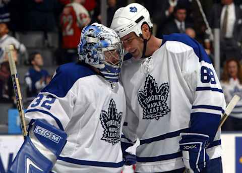 Eric Lindros #88 and Mikael Tellqvist #32, both of the Toronto Maple Leafs . (Photo By Dave Sandford/Getty Images)