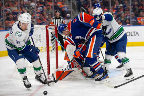 EDMONTON, CANADA – OCTOBER 14: Cody Ceci #5 of the Edmonton Oilers defends against Andrei Kuzmenko #96 of the Vancouver Canucks during the second period at Rogers Place on October 14, 2023 in Edmonton, Canada. (Photo by Codie McLachlan/Getty Images)