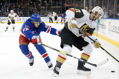 William Karlsson #71 of the Vegas Golden Knights skates with the puck against Ryan Lindgren #55 of the New York Rangers