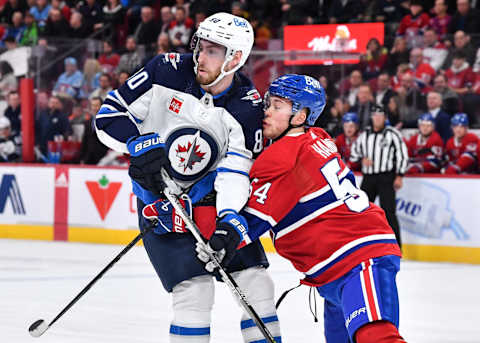 MONTREAL, CANADA – JANUARY 17: Pierre-Luc Dubois #80 of the Winnipeg Jets and Jordan Harris #54 of the Montreal Canadiens skate against each other during the first period at Centre Bell on January 17, 2023 in Montreal, Quebec, Canada. The Montreal Canadiens defeated the Winnipeg Jets 4-1. (Photo by Minas Panagiotakis/Getty Images)