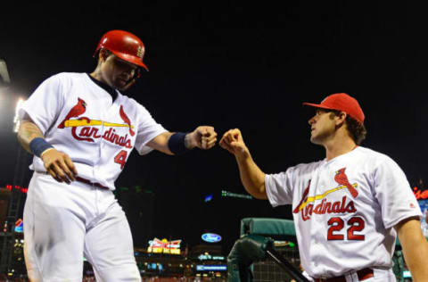 Aug 24, 2016; St. Louis, MO, USA; St. Louis Cardinals catcher Yadier Molina (4) is congratulated by manager Mike Matheny (22) after scoring during the seventh inning against the New York Mets at Busch Stadium. Mandatory Credit: Jeff Curry-USA TODAY Sports