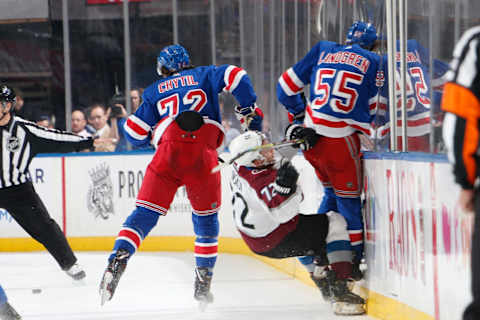 Ryan Lindgren #55 of the New York Rangers throws a hit against Joonas Donskoi #72 of the Colorado Avalanche