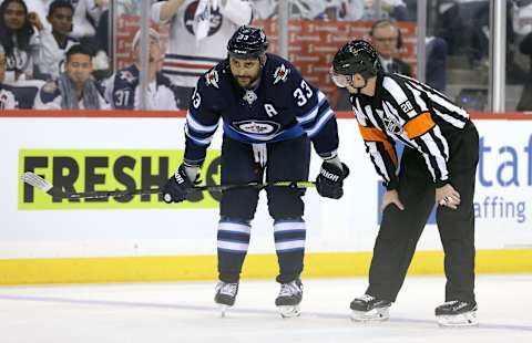 Dustin Byfuglien of the Winnipeg Jets chats to a referee during a break in action with the St. Louis Blues in Game One of the Western Conference First Round during the 2019 NHL Stanley Cup Playoffs at Bell MTS Place on April 10, 2019.