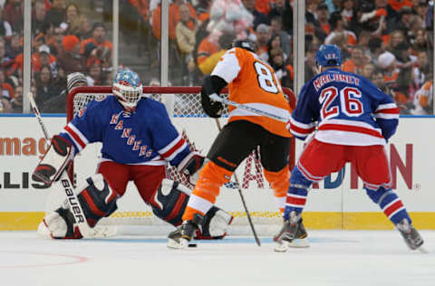 Eric Lindros Lindros #88 of the Philadelphia Flyers is stopped by John Vanbiesbrouck #34 and Dave Maloney #26 of the New York Rangers (Photo by Jim McIsaac/Getty Images)