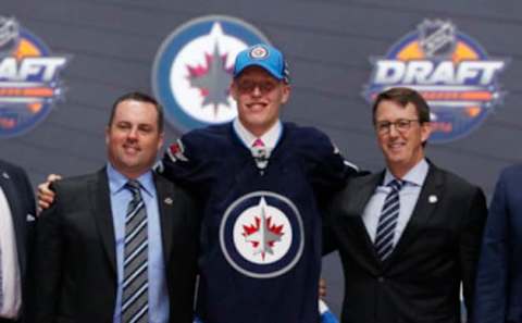 Jun 24, 2016; Buffalo, NY, USA; Patrik Laine poses for a photo with team officials after being selected as the number two overall draft pick by the Winnipeg Jets in the first round of the 2016 NHL Draft at the First Niagra Center. Mandatory Credit: Timothy T. Ludwig-USA TODAY Sports