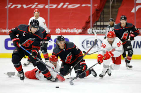 RALEIGH, NORTH CAROLINA – MARCH 04: Jordan Staal #11 of the Carolina Hurricanes skates with the puck as teammate Brady Skjei #76 battles for position against Robby Fabbri #14 and Sam Gagner #89 of the Detroit Red Wings during the first period of their game at PNC Arena on March 04, 2021, in Raleigh, North Carolina. (Photo by Jared C. Tilton/Getty Images)