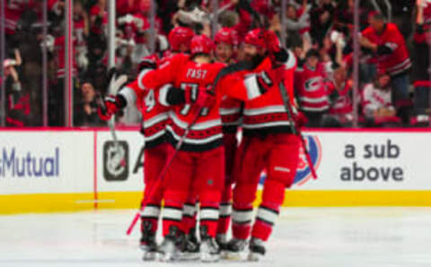 May 11, 2023; Raleigh, North Carolina, USA; Carolina Hurricanes center Jesperi Kotkaniemi (82) is congratulated by right wing Jesper Fast (71) defenseman Brent Burns (8) and defenseman Jaccob Slavin (74) after his goal against the New Jersey Devils during the second period in game five of the second round of the 2023 Stanley Cup Playoffs at PNC Arena. Mandatory Credit: James Guillory-USA TODAY Sports