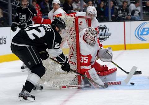 Jan 11, 2016; Los Angeles, CA, USA; Detroit Red Wings goalie Jimmy Howard (35) make a save off a shot by Los Angeles Kings center Trevor Lewis (22) in the first period of the game at Staples Center. Mandatory Credit: Jayne Kamin-Oncea-USA TODAY Sports