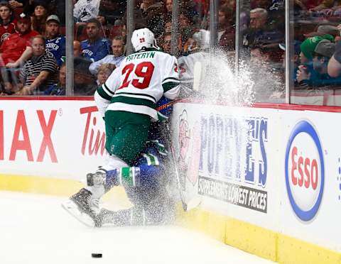 VANCOUVER, BC – DECEMBER 4: Greg Pateryn #29 of the Minnesota Wild checks Jake Virtanen #18 of the Vancouver Canucks into the boards during their NHL game at Rogers Arena December 4, 2018 in Vancouver, British Columbia, Canada. (Photo by Jeff Vinnick/NHLI via Getty Images)