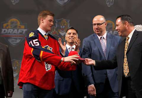 SUNRISE, FL – JUNE 26: Lawson Crouse, 11th overall selection by the Florida Panthers, is given a Panthers hat onstage during Round One of the 2015 NHL Draft at BB&T Center on June 26, 2015 in Sunrise, Florida. (Photo by Eliot J. Schechter/NHLI via Getty Images)