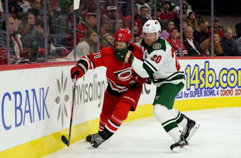 RALEIGH, NC – DECEMBER 07: Sebastian Aho #20 of the Carolina Hurricanes and Ryan Suter #20 of the Minnesota Wild battles along the boards during an NHL game on December 7, 2019 at PNC Arena in Raleigh, North Carolina. (Photo by Gregg Forwerck/NHLI via Getty Images)