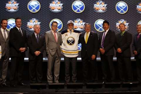 Jun 27, 2014; Philadelphia, PA, USA; Sam Reinhart poses for a photo with team officials after being selected as the number two overall pick to the Buffalo Sabres in the first round of the 2014 NHL Draft at Wells Fargo Center. Mandatory Credit: Bill Streicher-USA TODAY Sports