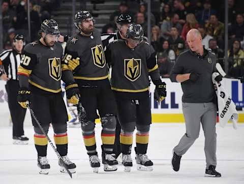 LAS VEGAS, NEVADA – FEBRUARY 13: Alex Tuch #89 of the Vegas Golden Knights is helped off the ice by teammates Chandler Stephenson #20 and Cody Eakin #21 after Tuch appeared to hurt his left knee in the third period of a game against the St. Louis Blues at T-Mobile Arena on February 13, 2020 in Las Vegas, Nevada. The Golden Knights defeated the Blues 6-5 in overtime. (Photo by Ethan Miller/Getty Images)