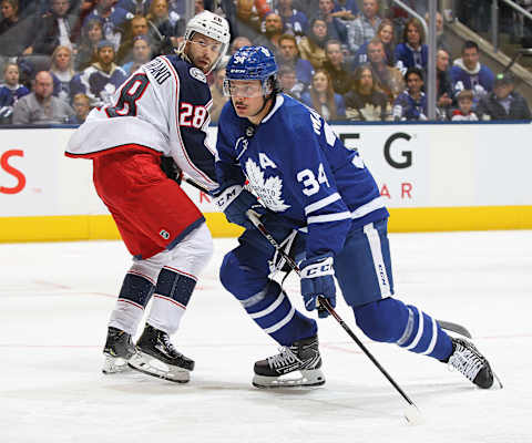 TORONTO, ON – OCTOBER 21: Oliver Bjorkstrand #28 of the Columbus Blue Jackets skates against Auston Matthews #34 of the Toronto Maple Leafs.. (Photo by Claus Andersen/Getty Images)