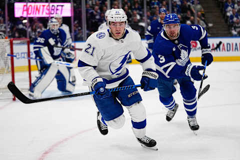 Apr 18, 2023; Toronto, Ontario, CAN; Tampa Bay Lightning forward Brayden Point (21) and Toronto Maple Leafs defenseman Justin Holl (3) chase after the puck during game one of the first round of the 2023 Stanley Cup Playoffs at Scotiabank Arena. Mandatory Credit: John E. Sokolowski-USA TODAY Sports