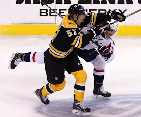 BOSTON – SEPTEMBER 24: (third period) Boston Bruins left wing Justin Florek (#57) puts a hit on Washington Capitals defenseman Patrick Wey (#56) in the third period. Boston Bruins play Washington Capitals in a preseason exhibition game at TD Garden. (Photo by Barry Chin/The Boston Globe via Getty Images)