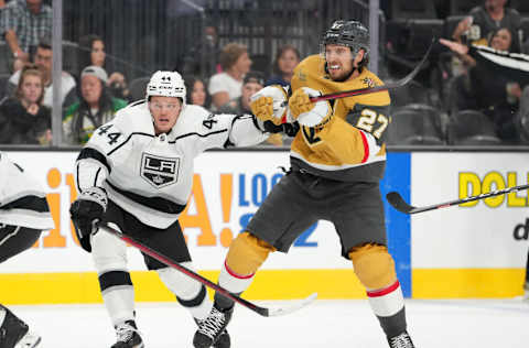 Sep 26, 2022; Las Vegas, Nevada, USA; Los Angeles Kings defenseman Mikey Anderson (44) slows Vegas Golden Knights defenseman Shea Theodore (27) during the second period of a preseason game at T-Mobile Arena. Mandatory Credit: Stephen R. Sylvanie-USA TODAY Sports