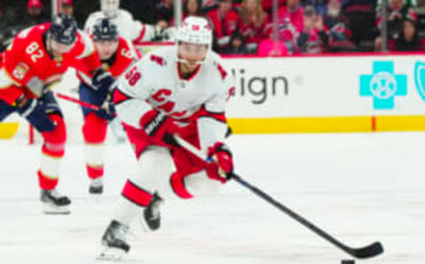 Sep 27, 2023; Raleigh, North Carolina, USA; Carolina Hurricanes left wing Michael Bunting (58) skates with the puck against the Florida Panthers during the third period at PNC Arena. Mandatory Credit: James Guillory-USA TODAY Sports