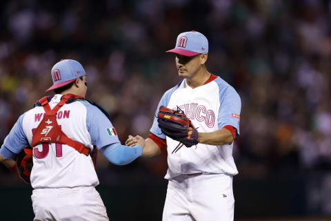 Pitcher Giovanny Gallegos and Alexis Wilson of Team Mexico hug after beating Team Great Britain 2-1 during the World Baseball Classic Pool C game at Chase Field. (Photo by Chris Coduto/Getty Images)