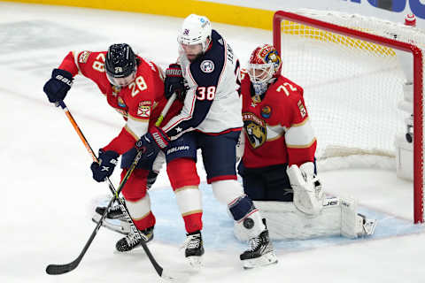 Dec 13, 2022; Sunrise, Florida, USA; Columbus Blue Jackets center Boone Jenner (38) attempts to redirect the puck between Florida Panthers defenseman Josh Mahura (28) and goaltender Sergei Bobrovsky (72) during the third period at FLA Live Arena. Mandatory Credit: Jasen Vinlove-USA TODAY Sports