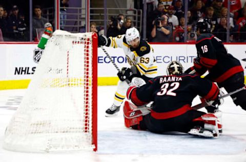 RALEIGH, NORTH CAROLINA – MAY 10: Antti Raanta #32 of the Carolina Hurricanes makes a first period save against Brad Marchand #63 of the Boston Bruins in Game Five of the First Round of the 2022 Stanley Cup Playoffs at PNC Arena on May 10, 2022, in Raleigh, North Carolina. (Photo by Jared C. Tilton/Getty Images)