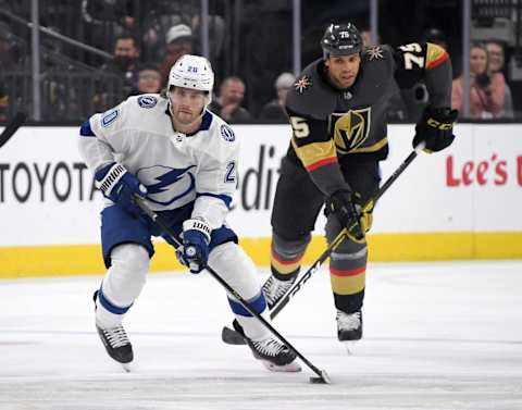 LAS VEGAS, NEVADA – FEBRUARY 20: Blake Coleman #20 of the Tampa Bay Lightning skates with the puck ahead of Ryan Reaves #75 of the Vegas Golden Knights in the first period of their game at T-Mobile Arena on February 20, 2020 in Las Vegas, Nevada. (Photo by Ethan Miller/Getty Images)