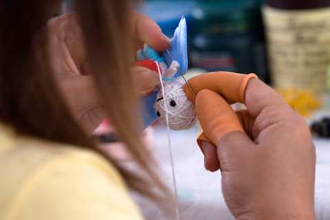 A handmade voodoo doll being made with a single thread of cotton and miscellaneous accessories. (Photo by Thierry Falise/LightRocket via Getty Images)