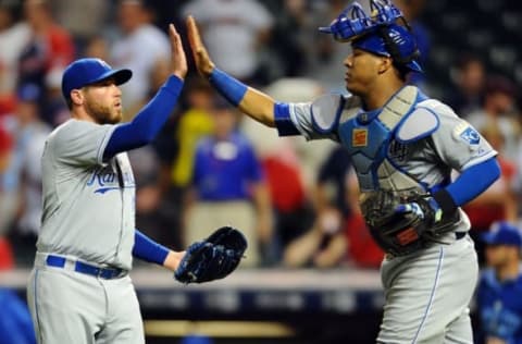 Sep 15, 2015; Cleveland, OH, USA; Kansas City Royals relief pitcher Greg Holland (56) celebrates with catcher Salvador Perez (13) after defeating the Cleveland Indians 2-0 at Progressive Field. Mandatory Credit: Ken Blaze-USA TODAY Sports