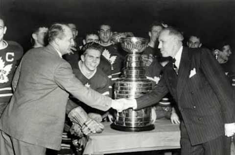 Toronto Maple Leafs 1949 head coach Hap Day shakes hands with NHL President Clarence Campbell (Photo by B Bennett/Getty Images)