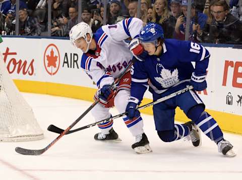 Dec 28, 2019; Toronto, Ontario, CAN; New York Rangers forward Ryan Strome (16) battles for the puck with Toronto Maple Leafs forward Mitchell Marner (16) in overtime at Scotiabank Arena. Mandatory Credit: Dan Hamilton-USA TODAY Sports