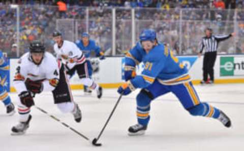 Jan 2, 2017; St. Louis, MO, USA; Chicago Blackhawks defenseman Niklas Hjalmarsson (4) and St. Louis Blues right wing Vladimir Tarasenko (91) battle for the puck during the 2016 Winter Classic ice hockey game at Busch Stadium. Mandatory Credit: Jasen Vinlove-USA TODAY Sports