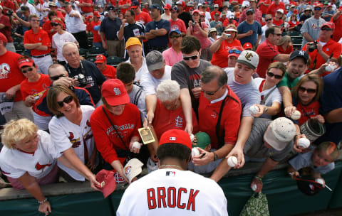 JUPITER, FL – MARCH 10: Hall-of-Famer Lou Brock #20 of the St Louis Cardinals signs autographs for fans before taking on the Washington Nationals at Roger Dean Stadium on March 10, 2010 in Jupiter, Florida. (Photo by Doug Benc/Getty Images)