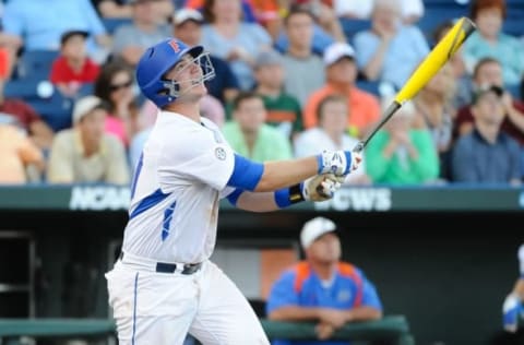 Jun 13, 2015; Omaha, NE, USA; Florida Gators infielder Peter Alonso (20) drives in a run with a sacrifice fly against the Miami Hurricanes in the fourth inning in the 2015 College World Series at TD Ameritrade Park. Mandatory Credit: Steven Branscombe-USA TODAY Sports