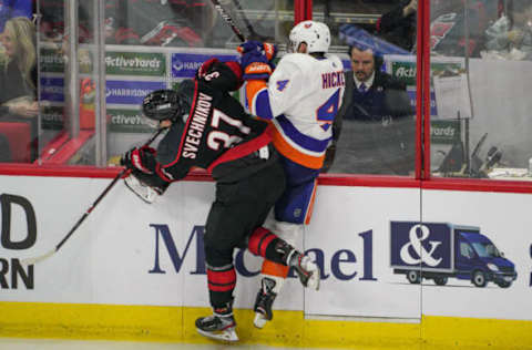 RALEIGH, NC – MAY 03: Carolina Hurricanes right wing Andrei Svechnikov (37) checks New York Islanders defenseman Thomas Hickey (4) into the glass during a game between the Carolina Hurricanes and the New York Islanders on March 3, 2019 at the PNC Arena in Raleigh, NC. (Photo by Greg Thompson/Icon Sportswire via Getty Images)