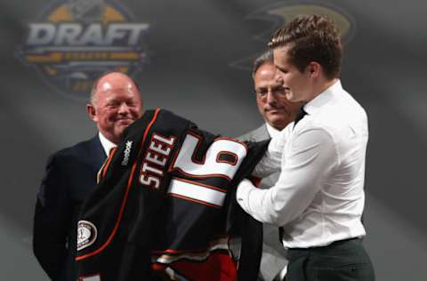 BUFFALO, NY: Sam Steel puts on his jersey after being selected 30th overall by the Anaheim Ducks during the 2016 NHL Draft on June 24, 2016. (Photo by Dave Sandford/NHLI via Getty Images)