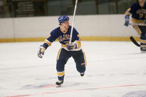 American professional hockey player Joe Mullen, forward for the St. Louis Blues, skates on the ice during a game with the New York Rangers at Madison Square Garden, New York, New York, January 1986. (Photo by Bruce Bennett Studios/Getty Images)