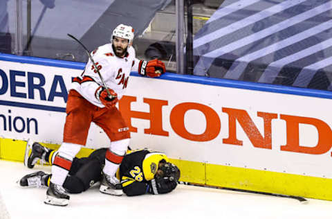 TORONTO, ONTARIO – AUGUST 19: Jordan Martinook #48 of the Carolina Hurricanes is called for a roughing penalty on Ondrej Kase #28 of the Boston Bruins during the second period in Game Five of the Eastern Conference First Round during the 2020 NHL Stanley Cup Playoffs at Scotiabank Arena on August 19, 2020, in Toronto, Ontario. (Photo by Elsa/Getty Images)