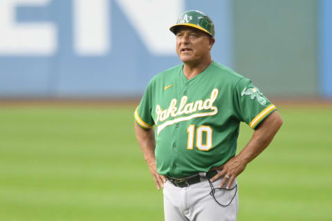 Aug 10, 2021; Cleveland, Ohio, USA; Oakland Athletics first base coach Mike Aldrete (10) stands on the field during a game against the Cleveland Indians at Progressive Field. Mandatory Credit: David Richard-USA TODAY Sports