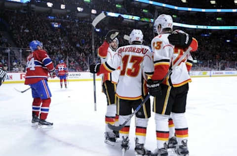 Mar 20, 2016; Montreal, Quebec, CAN; Calgary Flames forward Johnny Gaudreau (13) celebrates with teammates including Sean Monahan (23) after scoring a goal against the Montreal Canadiens during the third period at the Bell Centre. Mandatory Credit: Eric Bolte-USA TODAY Sports