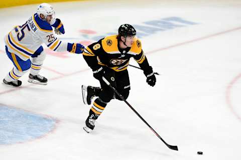 Apr 13, 2021; Boston, Massachusetts, USA; Boston Bruins defenseman Mike Reilly (6) skates with the puck in front of Buffalo Sabres center Arttu Ruotsalainen (25) during the first period at TD Garden. Mandatory Credit: Brian Fluharty-USA TODAY Sports