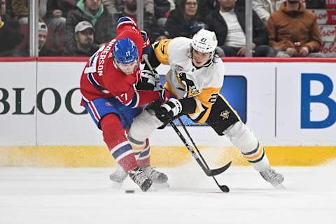 MONTREAL, CANADA – DECEMBER 13: Josh Anderson #17 of the Montreal Canadiens and Ryan Graves #27 of the Pittsburgh Penguins battle for the puck during the third period at the Bell Centre on December 13, 2023 in Montreal, Quebec, Canada. The Pittsburgh Penguins defeated the Montreal Canadiens 4-3 in a shootout. (Photo by Minas Panagiotakis/Getty Images)