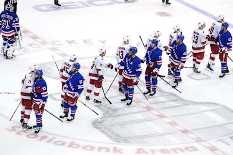 The Carolina Hurricanes shake hands with the New York Rangers after Game Three. (Photo by Andre Ringuette/Freestyle Photo/Getty Images)